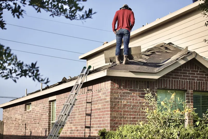 Professional roofer working on a residential roof in Salinas